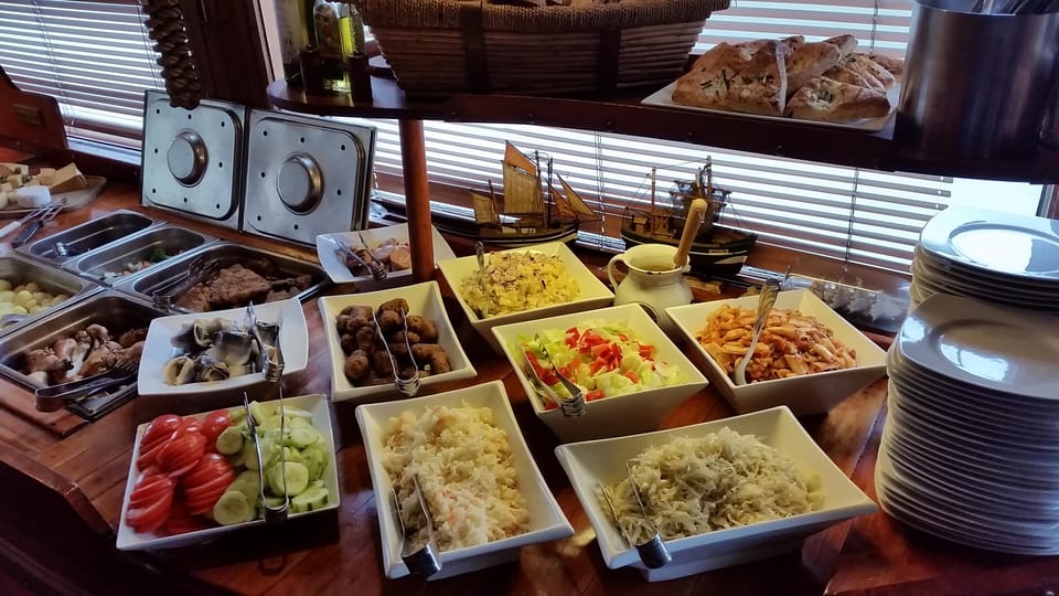 Prague: Vltava River Evening Dinner Cruise - The boat experience: cozy seating and a real reason to stay inside